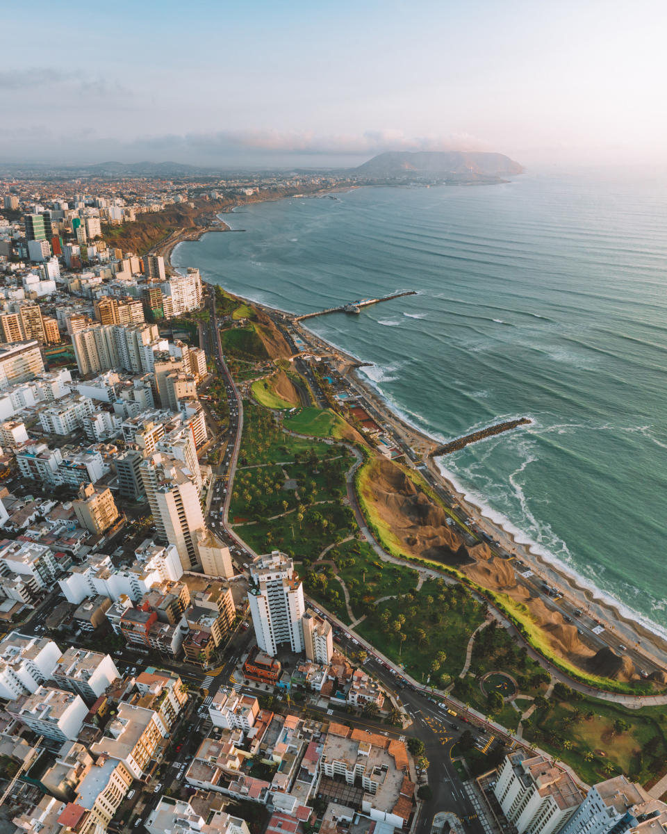 An aerial view of city buildings against the sea in Lima.