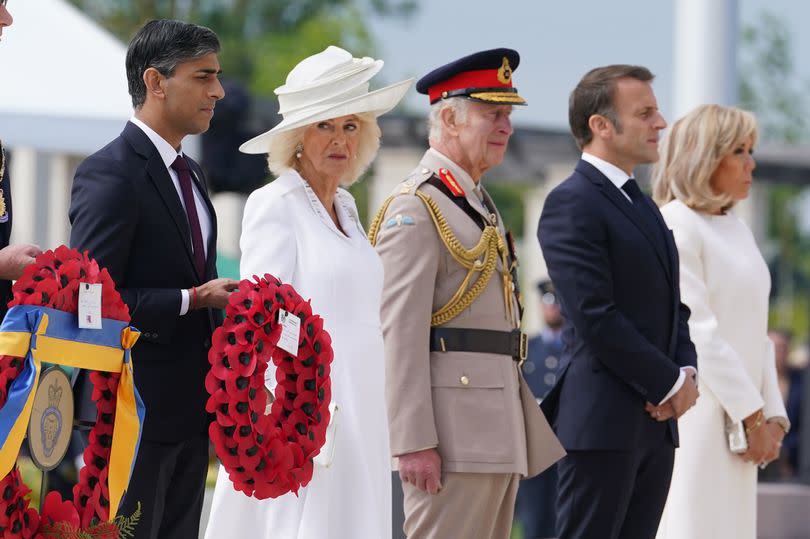 King Charles and Queen Camilla pay their respects alongside Rishi Sunak