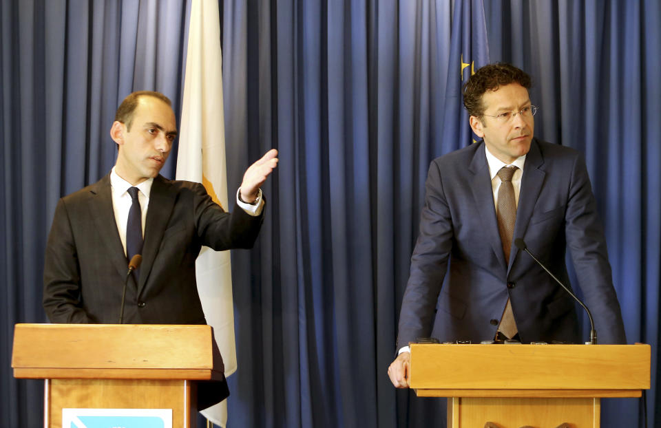 Cyprus' Finance Minister Harris Georgiades, left, and Eurogroup President Jeroen Dijsselbloem speaks to the media during a press conference at the Ministry of Finance in Nicosia, Cyprus, Monday, March 31, 2014. Cyprus has received a 10 billion euro bailout from the European Commission, the European Central Bank and the IMF, known as the Troika and has been subjected to three evaluations so far from its international lenders. (AP Photo/Philippos Christou)