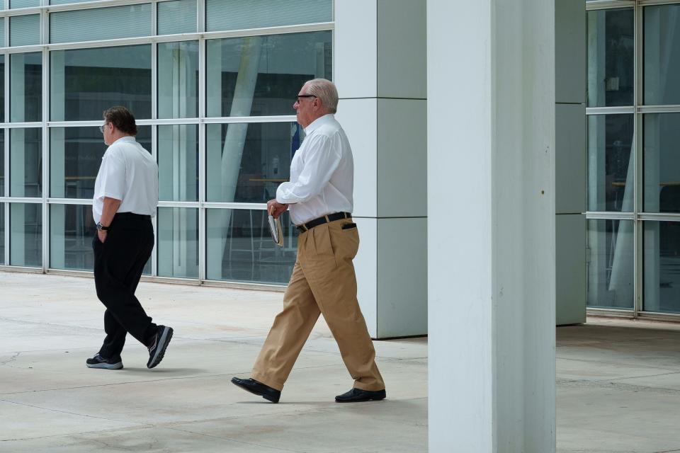 Backpage.com co-founder Michael Lacey (right) leaves a hearing at Sandra Day O'Connor U.S. Courthouse in Phoenix with colleague Stephen Lemons on Aug. 18, 2023.