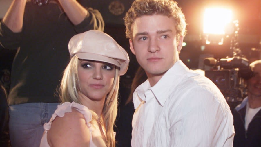 Britney Spears (left) included an encounter between Justin Timberlake (right) and singer Ginuwine in her new memoir. Above, Spears and Timberlake, her then-boyfriend, are shown in February 2002 at the Hollywood premiere of her movie “Crossroads.” (Photo: Kevin Winter/Getty Images)