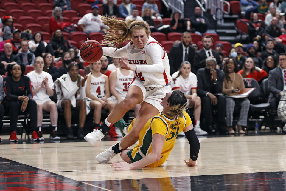 Texas Tech's Vivian Gray (12) charges through Baylor's Caitlin Bickle (51) during the second half of an NCAA college basketball game on Wednesday, Jan. 26, 2022, in Lubbock, Texas. (AP Photo/Brad Tollefson)