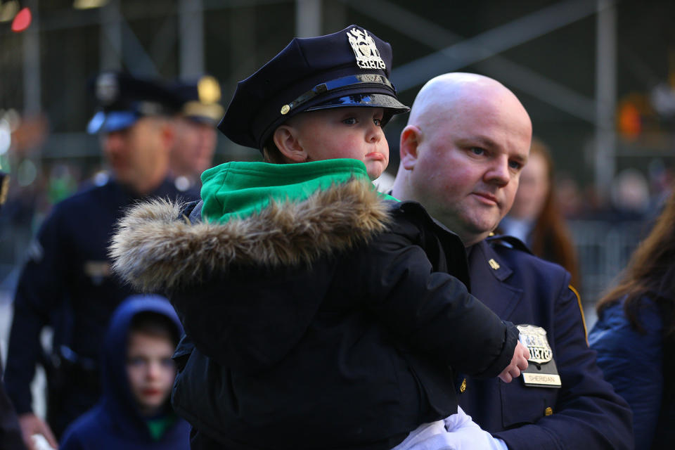 The son of a New York City police officer gets a ride as his dad marches in the St. Patrick's Day parade on March 16, 2019, in New York. (Photo: Gordon Donovan/Yahoo News) 