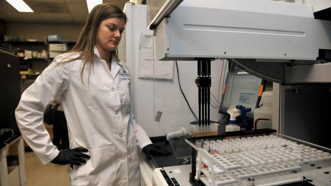 In this file image, research specialist Nicole Quinn of Johns Hopkins Medicine tests samples for sexually transmitted diseases in a February 15, 2011.