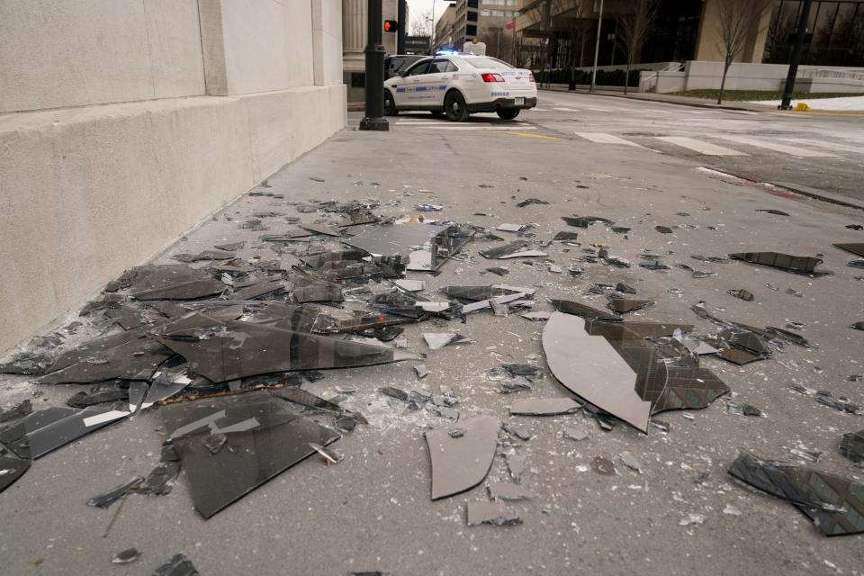 Broken window glass is scattered near the scene of an explosion in downtown Nashville, Tenn., Friday, Dec. 25, 2020. Buildings shook in the immediate area and beyond after a loud boom was heard early Christmas morning. (AP Photo/Mark Humphrey)