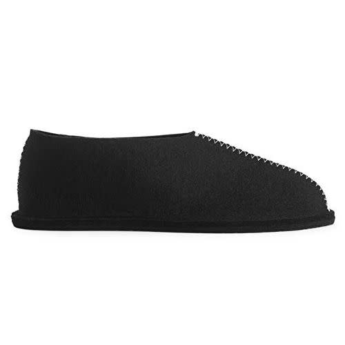 <p><a class="link " href="https://www.arket.com/en_gbp/homeware/living-room/product.pia-wall%C3%A9n-wool-slippers-black.1037447001.html" rel="nofollow noopener" target="_blank" data-ylk="slk:SHOP;elm:context_link;itc:0;sec:content-canvas">SHOP</a></p><p>Born from the mind of celebrated Scandinavian designer Pia Wallén and available at Arket, this wool shoe may well be the sleekest, most sophisticated slipper on the high street. </p><p>£79; <a href="https://www.arket.com/en_gbp/homeware/living-room/product.pia-wall%C3%A9n-wool-slippers-black.1037447001.html" rel="nofollow noopener" target="_blank" data-ylk="slk:arket.com;elm:context_link;itc:0;sec:content-canvas" class="link ">arket.com</a></p>