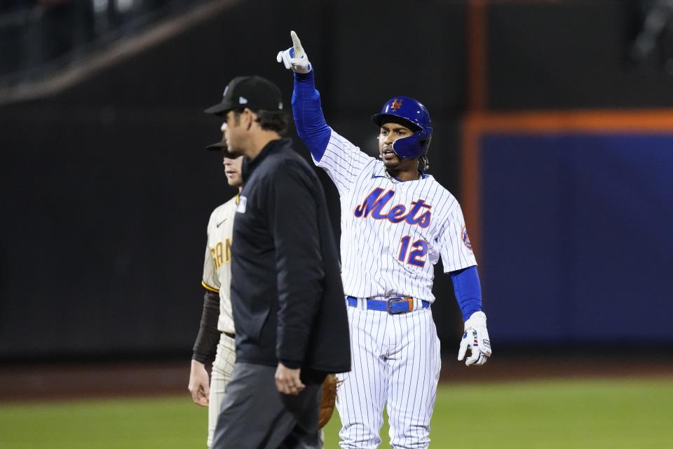 New York Mets' Francisco Lindor (12) gestures to his dugout after hitting an RBI-double of during the seventh inning a baseball game against the San Diego Padres, Monday, April 10, 2023, in New York. (AP Photo/Frank Franklin II)