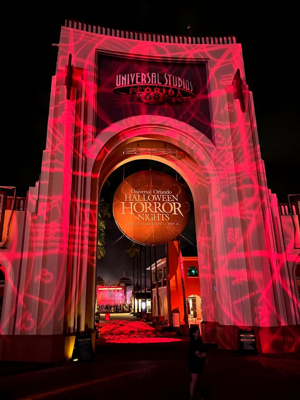 The Halloween Horror Nights sign is cast in an eerie red light at the end of HHN's opening night at Universal Orlando.