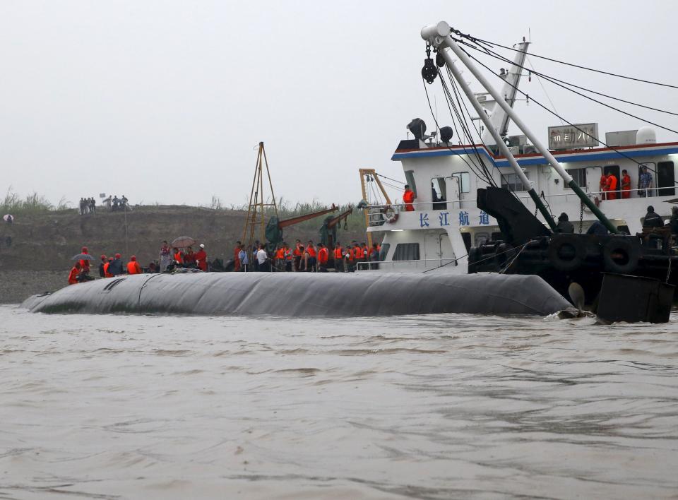 Rescue workers work on a sunken ship in the Jianli section of Yangtze River, Hubei province, China, June 2, 2015. Rescuers fought bad weather on Tuesday as they searched for more than 400 people, many of them elderly Chinese tourists, missing after a ship capsized on the Yangtze River in what was likely China's worst shipping disaster in almost 70 years. (REUTERS/Kim Kyung-Hoon)