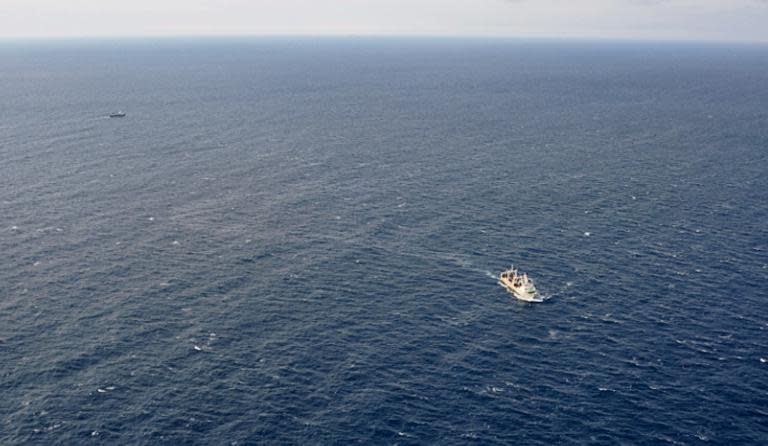 This handout picture taken and released by Russia's Emergency Ministry on April 2, 2015 shows ships carrying out a search operation in the Sea of Okhotsk where the trawler Dalny Vostok sank