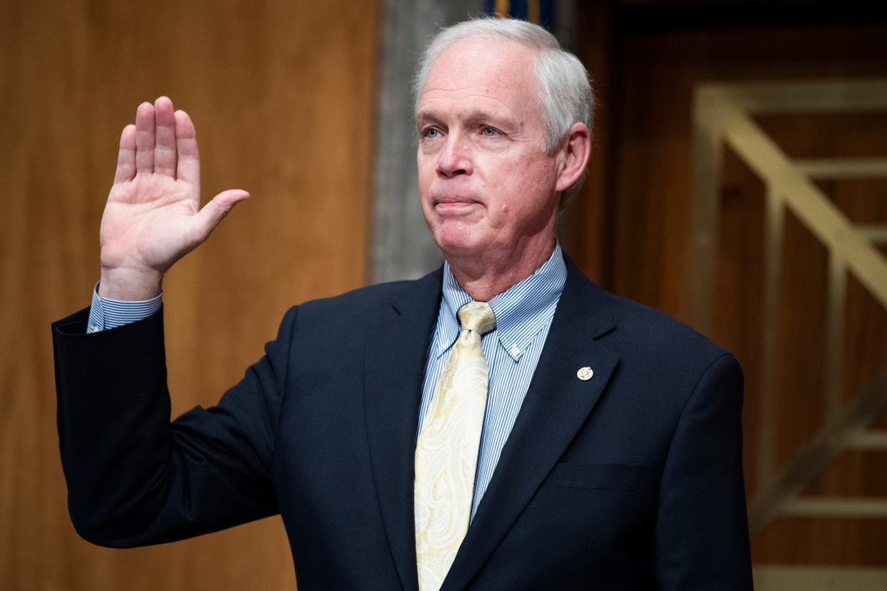 Republican Sen. Ron Johnson of Wisconsin, his right hand raised, swears in witnesses during the Senate Homeland Security and Governmental Affairs Committee hearing titled Early Outpatient Treatment: An Essential Part of a COVID-19 Solution, Part II, in Dirksen Building on Tuesday, December 8, 2020.