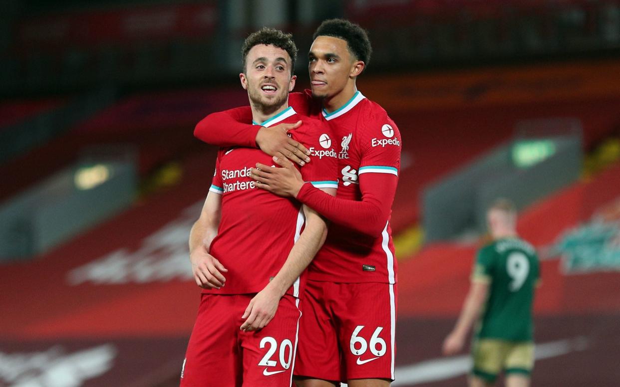 Liverpool's Diogo Jota celebrates scoring his side's second goal of the game with Trent Alexander-Arnold (right) during the Premier League match at Anfield, Liverpool.  - PA