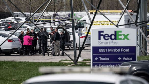 PHOTO: In this April 16, 2021, file photo, a group of crime scene investigators gather to speak in the parking lot of a FedEx SmartPost in Indianapolis. (Jon Cherry/Getty Images, FILE)