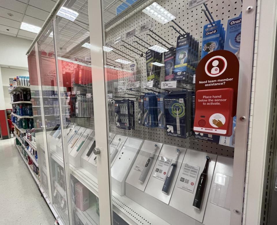 Toothbrushes are among the many products now locked behing security glass at a store.