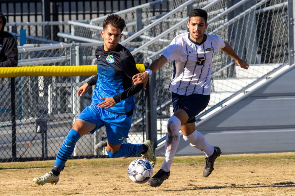 Oxnard College attacker Odin Rosten is chased by Merced's Giovanni Lopez in the CCCAA state semifinals at American River College in Sacramento on Friday. Oxnard won, 1-0.