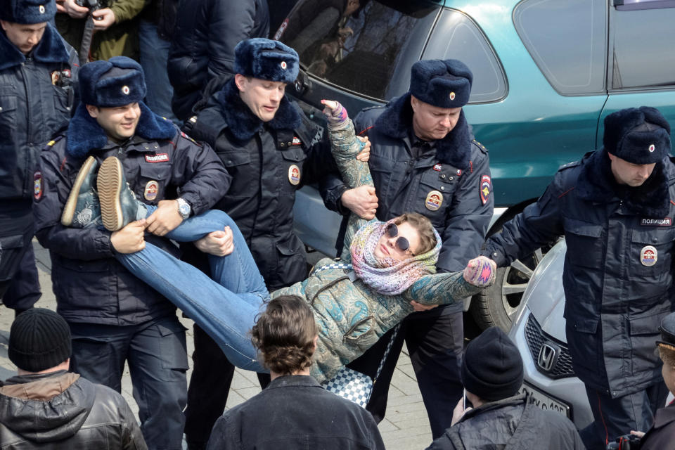 Police officers detain an opposition supporter during a rally in Vladivostok.