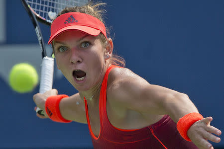 Simona Halep of Romania hits a return to Kateryna Bondarenko of Ukraine during their second round match at the U.S. Open Championships tennis tournament in New York, September 3, 2015. REUTERS/Carlo Allegri