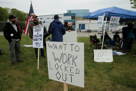 Locked-out members of the Local 651 International Brotherhood of Boilermakers union carry signs outside Westinghouse Electric's manufacturing facility in Newington, New Hampshire, U.S., May 22, 2017. REUTERS/Brian Snyder