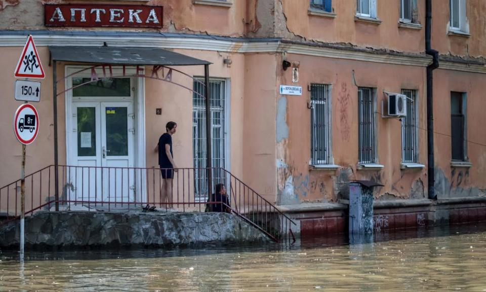 A man looks on at a flooded area in Kherson, Ukraine, 7 June 2023.