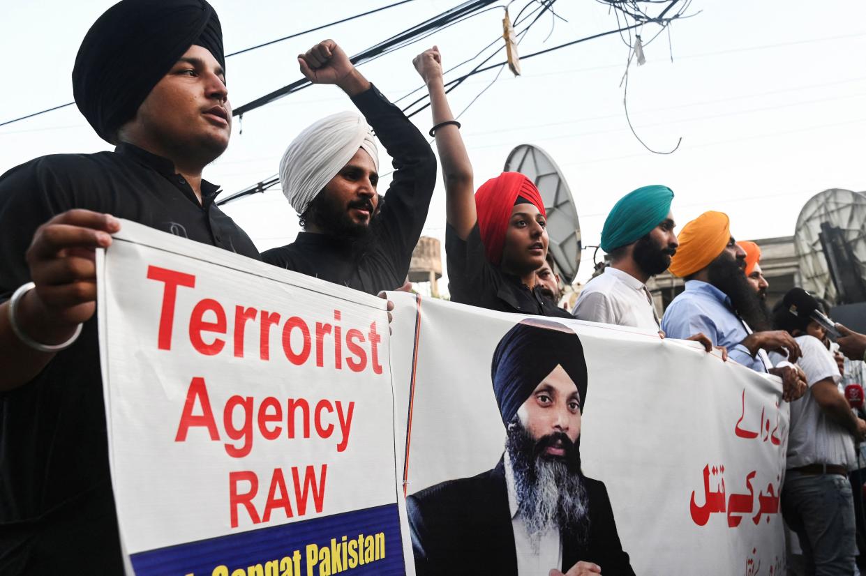 Protesters wearing turbans carry a banner that reads: Terrorist Agency RAW.