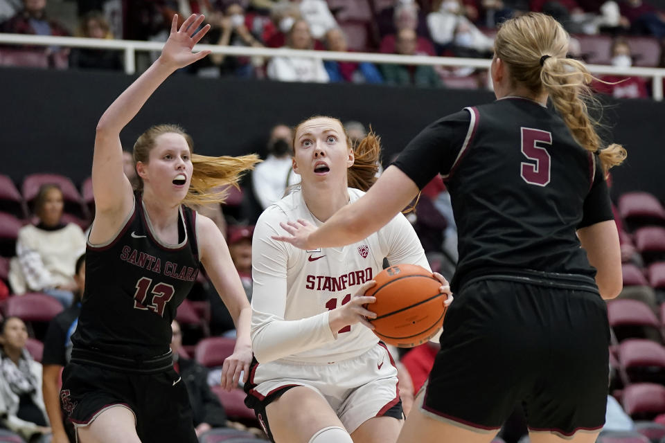 Stanford forward Ashten Prechtel, middle, drives to the basket against Santa Clara guard Lara Edmanson (13) and forward Olivia Pollerd (5) during the first half of an NCAA college basketball game in Stanford, Calif., Wednesday, Nov. 30, 2022. (AP Photo/Jeff Chiu)