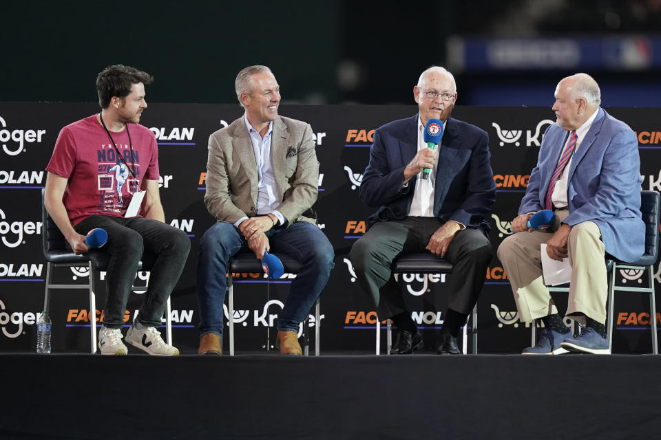 FILE - Baseball great and former Texas Rangers pitcher Nolan Ryan, second from right, speaks as Chuck Morgan, right, filmmaker Bradley Johnson, left, and his son Reid Ryan look on before a screening of a documentary film entitled "Facing Nolan" after a baseball ball game between the Atlanta Braves and the Rangers in Arlington, Texas, Sunday, May 1, 2022. (AP Photo/LM Otero, File)