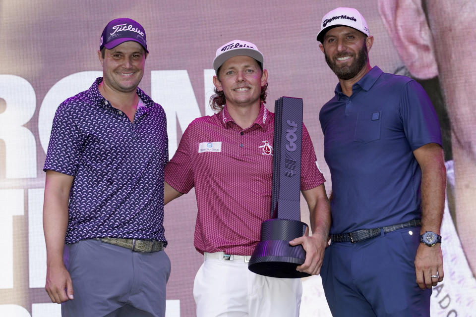 Cameron Smith winner of the LIV Golf Invitational-Chicago tournament stands with third place finisher Peter Uihlein, left, and second place finisher Dustin Johnson after the tournament Sunday, Sept. 18, 2022, in Sugar Hill, Ill. (AP Photo/Charles Rex Arbogast)