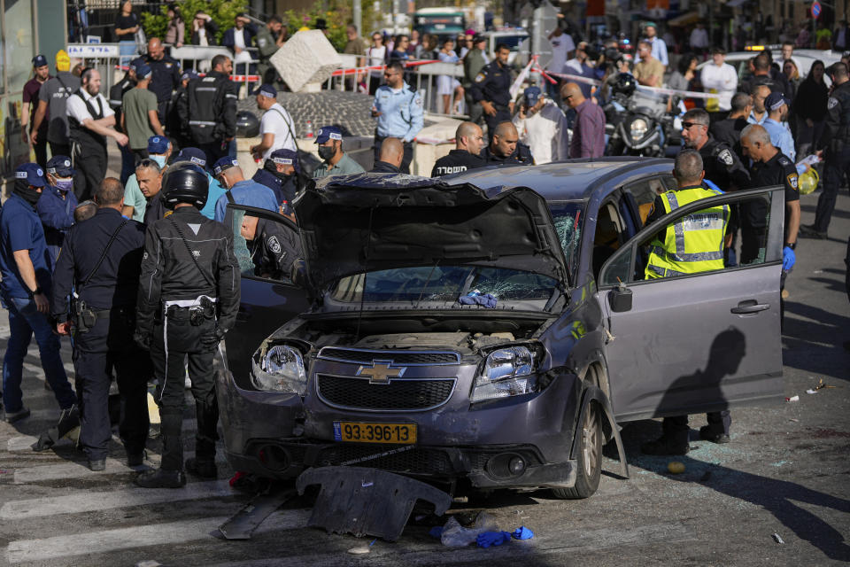 Israeli police examine the scene of a car ramming attack, in Jerusalem, Monday, April 24, 2023. Israeli Prime Minister Benjamin Netanyahu says multiple people have been attacked and wounded near a popular market in Jerusalem. (AP Photo/Ohad Zwigenberg)