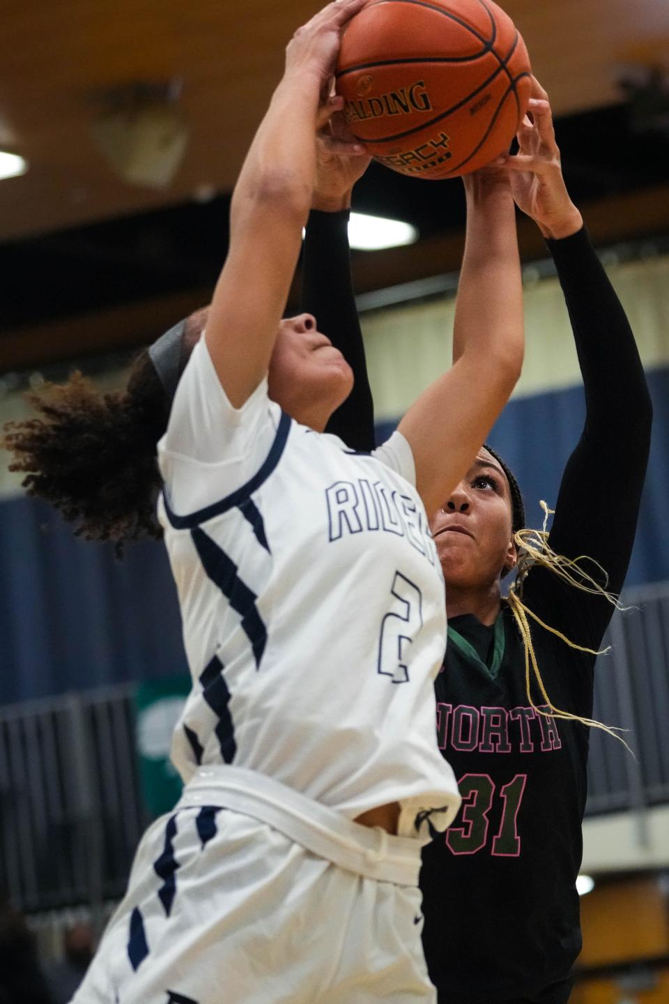 Des Moines Roosevelt's Arianna Jackson, left, fights for the ball against Des Moines North's Amani Jenkins during Friday's game at at Roosevelt High School.