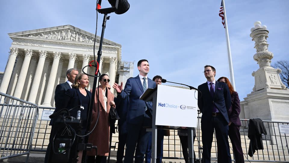 Chris Marchese (C), Director of NetChoice Litigation Center, speaks to the press outside the US Supreme Court in Washington, DC on February 26, 2024. In a case that could determine the future of social media, the US Supreme Court was asked today to decide whether a pair of state laws that limit content moderation are constitutional. (Photo by ANDREW CABALLERO-REYNOLDS / AFP) (Photo by ANDREW CABALLERO-REYNOLDS/AFP via Getty Images) - Andrew Caballero-Reynolds/AFP/Getty Images