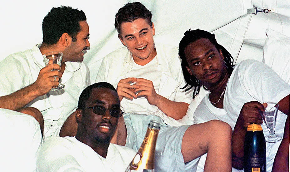 Leonardo DiCaprio enjoying some laughs with Diddy and his crew at one of the first White Parties in the Hamptons. (Getty Images) 