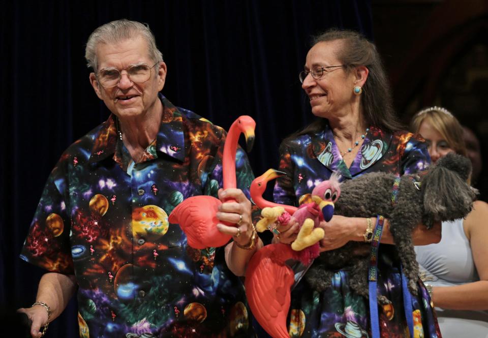 Artist Don Featherstone, 1996 Ig Nobel Prize winner and creator of the plastic pink flamingo lawn ornament, poses with his Nancy while being honored as a past recipient during a performance at the Ig Nobel Prize ceremony at Harvard University, in Cambridge, Mass., Thursday, Sept. 20, 2012. The Ig Nobel prize is an award handed out by the Annals of Improbable Research magazine for silly sounding scientific discoveries that often have surprisingly practical applications. (AP Photo/Charles Krupa)