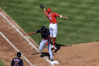 Cleveland Indians' Amed Rosario, left, reaches first base safely as Cincinnati Reds' Joey Votto, right, fields the ball during the fourth inning of a baseball game in Cincinnati, Sunday, April 18, 2021. (AP Photo/Aaron Doster)