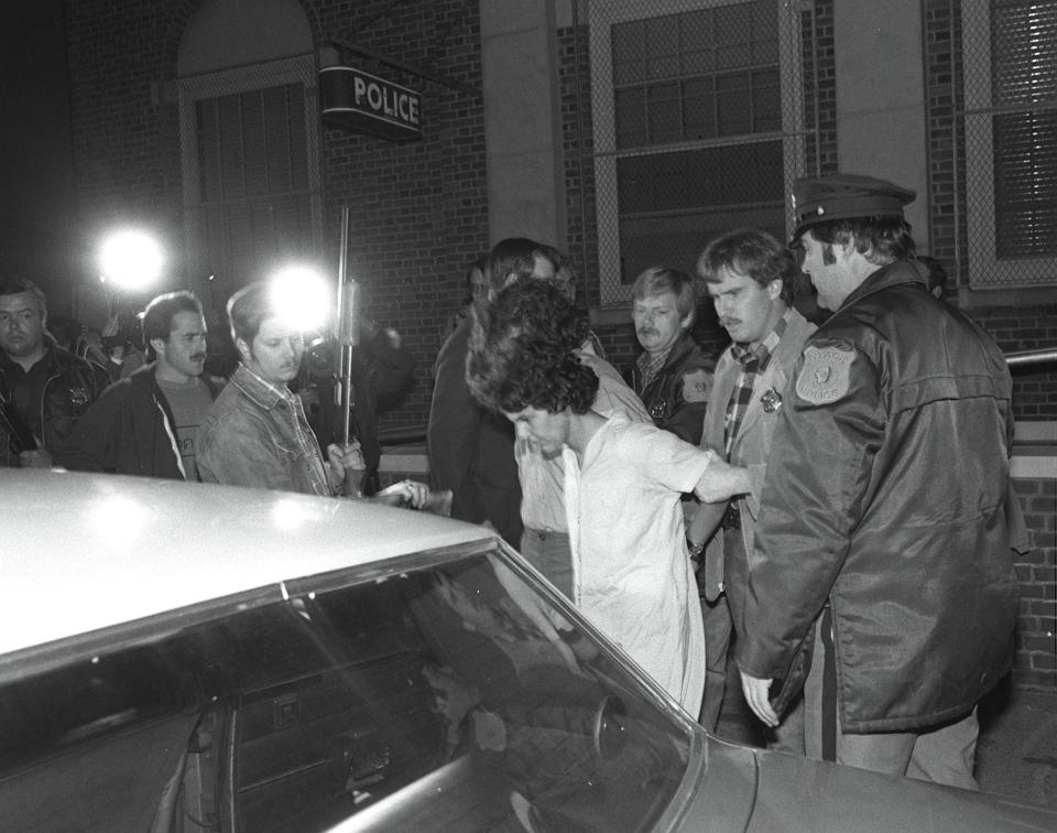 Kathy Boudin, a member of the Weather Underground in the 1970's, is lead from Nyack Police Station following her arraignment on felony murder charges in connection with the armed heist of a Brink's armored truck in Nanuet which ultimately led to the death of two Nyack Police officers and a Brink's guard  10/22/81 (The Journal News File photo)