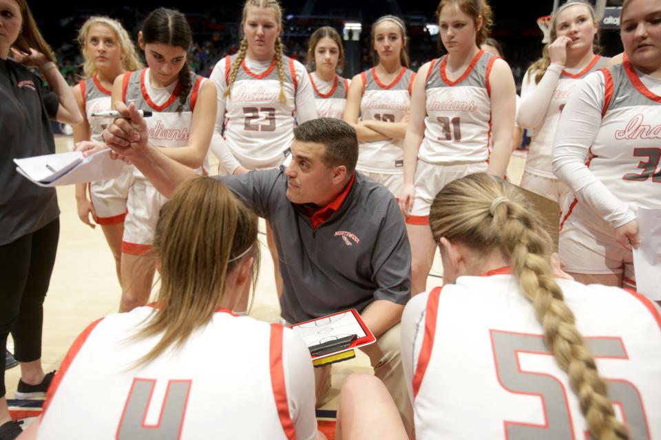 The Northwest girls basketball team huddles around head coach Kevin Lower during Thursday's OHSAA Division II state semifinal game against Proctorville Fairland.