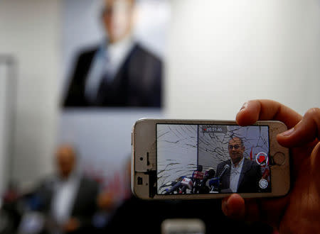 A journalist uses his mobile phone to shoot a video of Egyptian human rights lawyer and opposition leader Khaled Ali during a news conference about the upcoming 2018 presidential elections, in Cairo, Egypt January 17, 2018. REUTERS/Amr Abdallah Dalsh