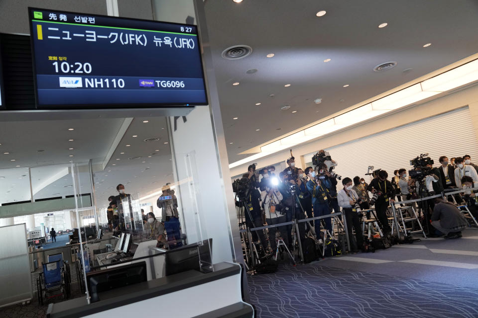 Journalists wait for Japan's former Princess Mako, the elder daughter of Crown Prince Akishino, and her husband Kei Komuro, to arrive to board an airplane to New York Sunday, Nov. 14, 2021, at Tokyo International Airport in Tokyo. (AP Photo/Eugene Hoshiko)