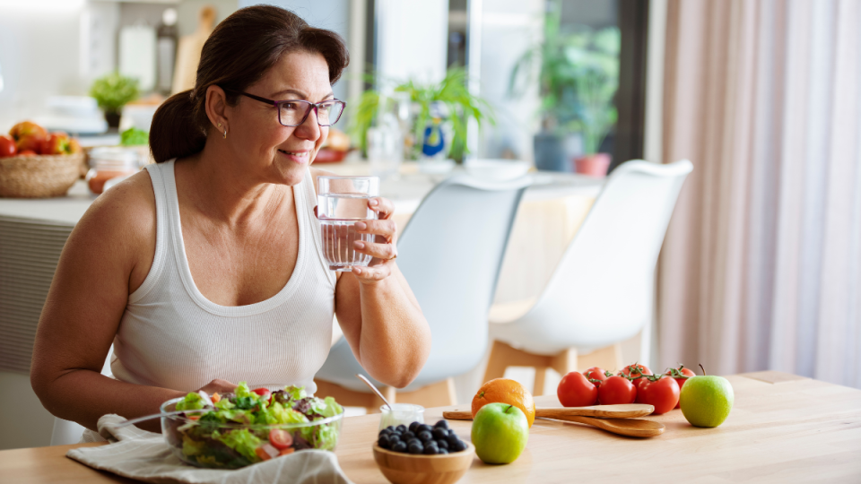 Woman eating salad and fruit 