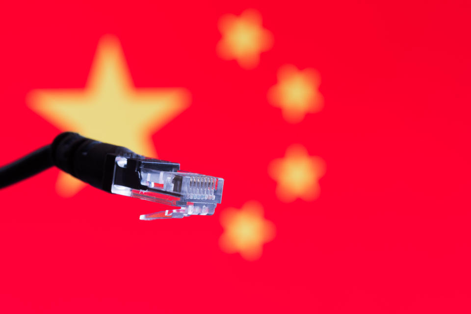 An unplugged network cable in front of a Chinese flag.