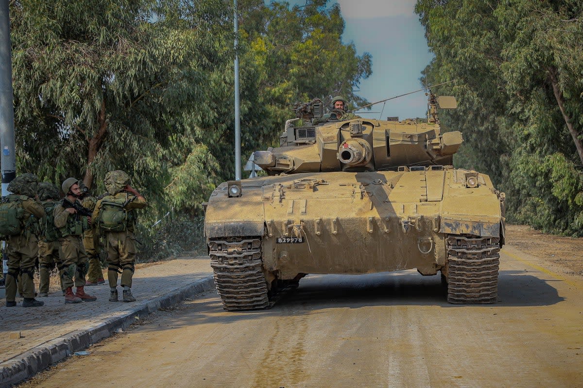 Israeli soldiers in Kfar Aza (Bel Trew/The Independent)