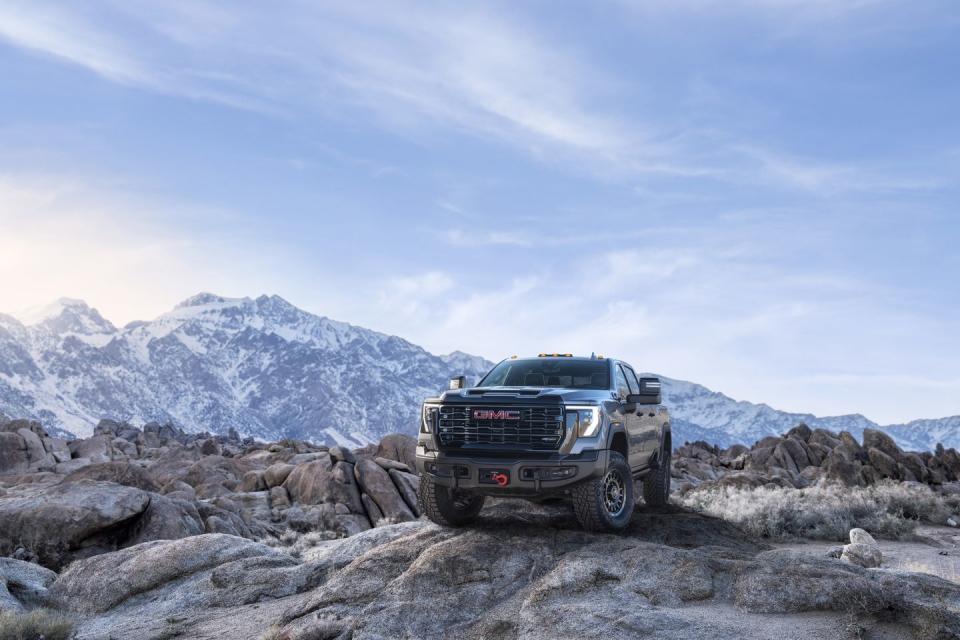 2024 gmc sierra 2500hd at4x aev edition in sterling metallic with mountains in the background
