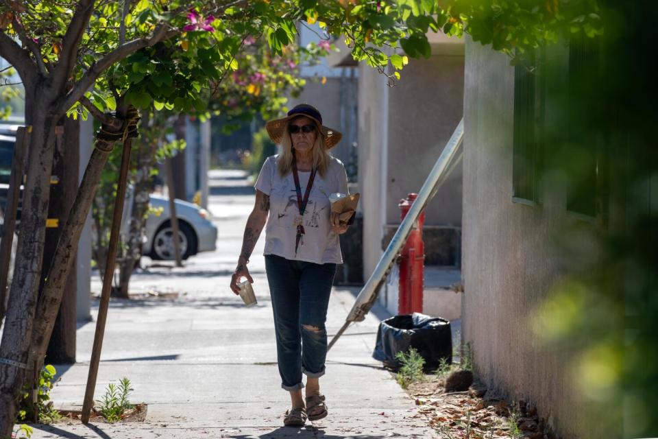 A person walks on a sidewalk.