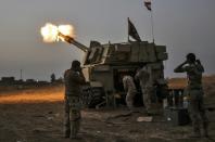 Iraqi forces fire a M109 self-propelled howitzer towards the village of Al-Muftuya from a position in Kani al-Harami, some 35 kilometres of Mosul, on October 19, 2016, during an operation against Islamic State group jihadists