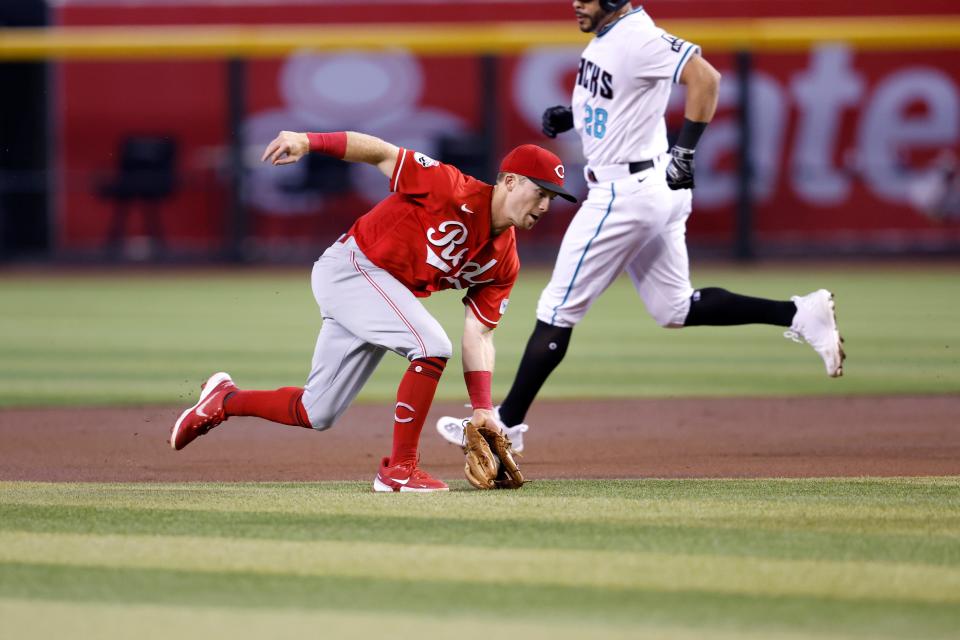 Matt McLain #9 of the Cincinnati Reds fields a ground ball during the first inning against the Arizona Diamondbacks at Chase Field on Aug. 27, 2023.