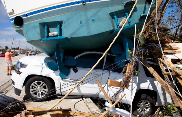 A large boat crushes a vehicle in Fort Myers Beach on Sept. 29, 2022. (Photo: Ted Richardson/For The Washington Post via Getty Images)