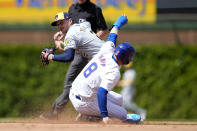 Milwaukee Brewers' Brice Turang looks to first after forcing Chicago Cubs' Ian Happ out at second during the fourth inning of a baseball game Friday, May 3, 2024, in Chicago. (AP Photo/Charles Rex Arbogast)