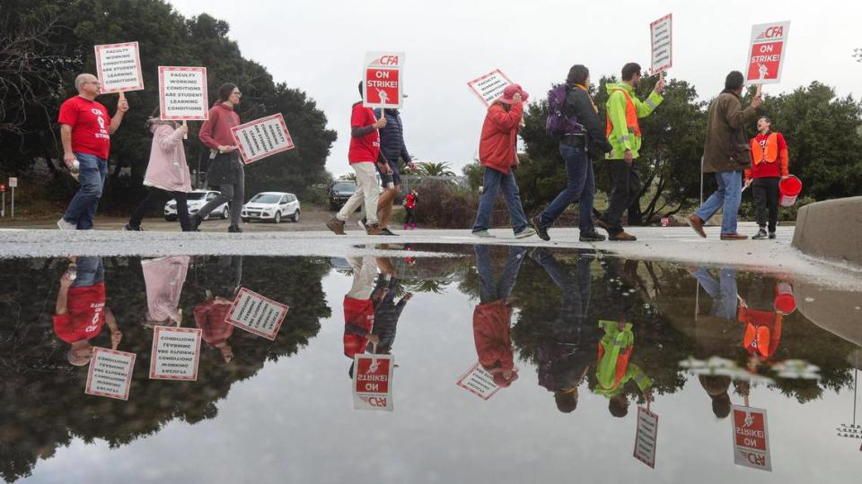 Striking Cal Poly faculty picket at the corner of California Boulevard and Highland Drive in San Luis Obispo on Jan. 22, 2024, as thousands of union members staged a walkout at all 23 California State University campuses.