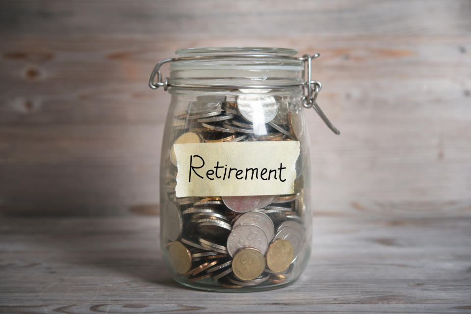 A jar filled with coins and labeled "Retirement"