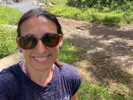 Dena Levitz in Costa Rica sitting on a rock where she meditated