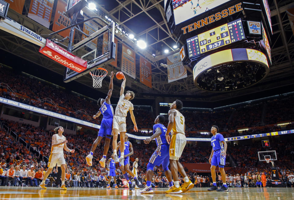 Tennessee forward Drew Pember (3) dunks the ball over Memphis center Malcolm Dandridge (23) during the first half of an NCAA college basketball game Saturday, Dec. 14, 2019, in Knoxville, Tenn. (AP Photo/Wade Payne)